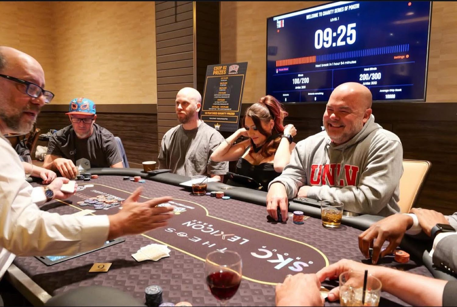 A Charity Series of Poker cash table in play, The Poker Timer clock behind